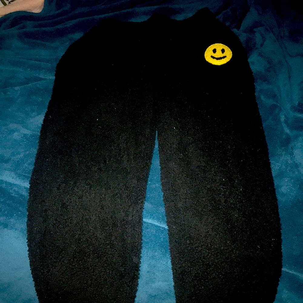 Black fuzzy pajama pants with smoky face